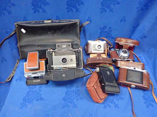 A POLAROID SX-70 LAND CAMERA AND A LAND CAMERA AUTOMATIC 100