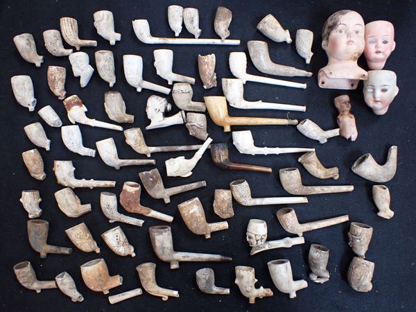 A COLLECTION OF EXCAVATED CLAY PIPES