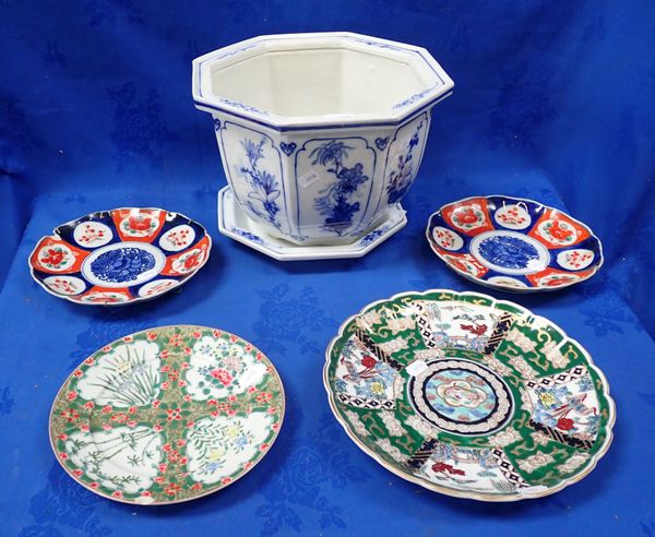 AN ASIAN BLUE AND WHITE JARDINIERE AND STAND