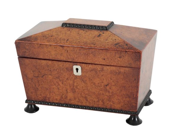 A REGENCY BURR WALNUT AND EBONISED TEA CADDY