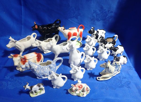 A COLLECTION OF CERAMIC COW CREAMERS