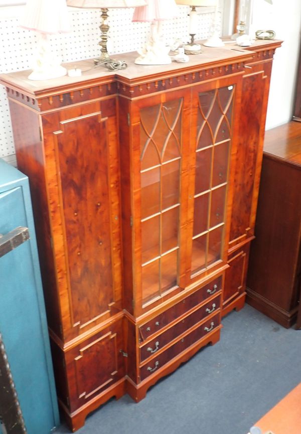 A YEW VENEERED BREAKFRONT CABINET