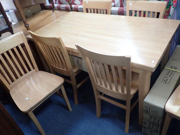 A MODERN LIGHT WOOD DINING TABLE AND EIGHT CHAIRS
