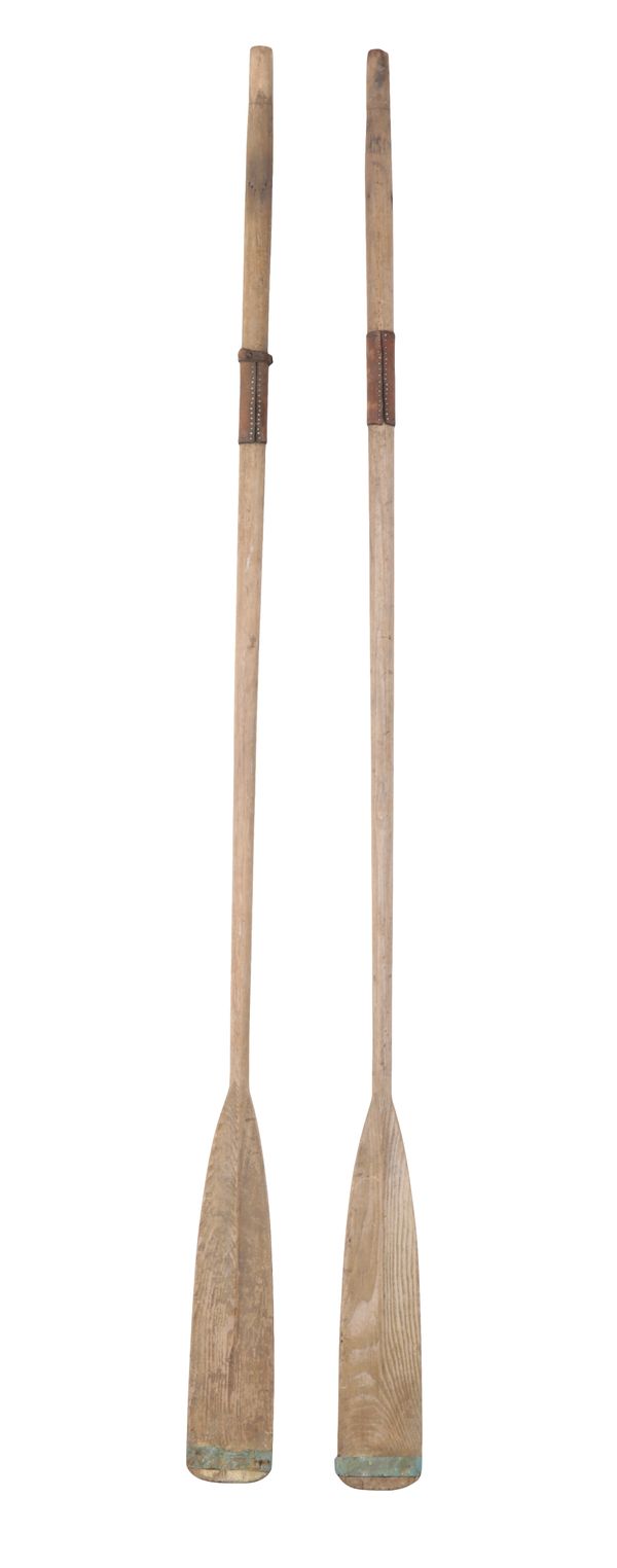 A PAIR OF TALL WOOD AND LEATHER BANDED OARS