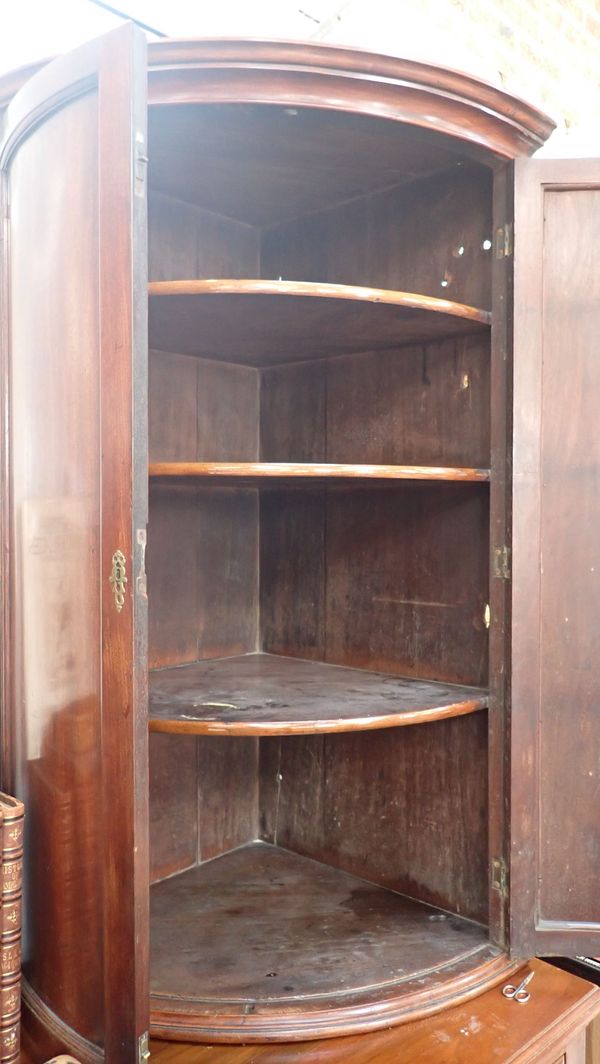 A MAHOGANY BOW-FRONTED HANGING CORNER CUPBOARD