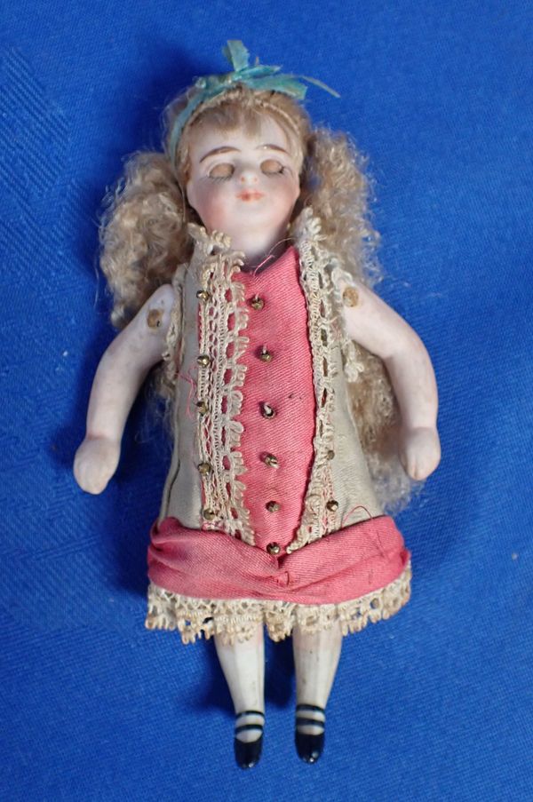 A JOINTED BISQUE DOLL WITH MOVING EYES