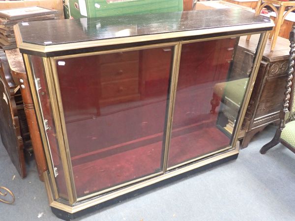 A EBONISED AND BRASS DISPLAY CABINET