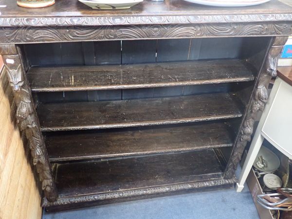 A VICTORIAN CARVED OAK OPEN BOOKCASE