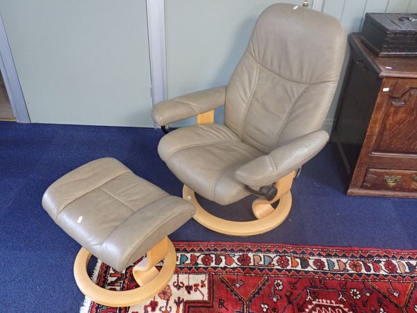 A EKORNES STRESSLESS ARMCHAIR WITH STOOL