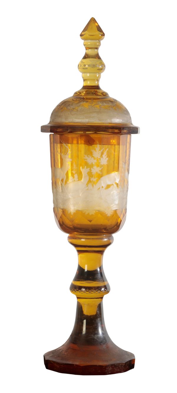 A BOHEMIAN AMBER GLASS GOBLET AND COVER