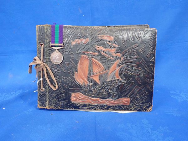 A PHOTOGRAPH/POSTCARD ALBUM OF NATIONAL SERVICE IN CYPRUS 1957, WITH SERVICE MEDAL