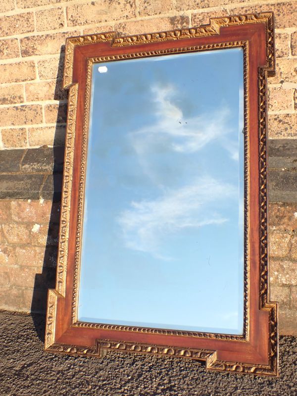 A  CARVED AND GILT AND MAHOGANY FRAMED MIRROR