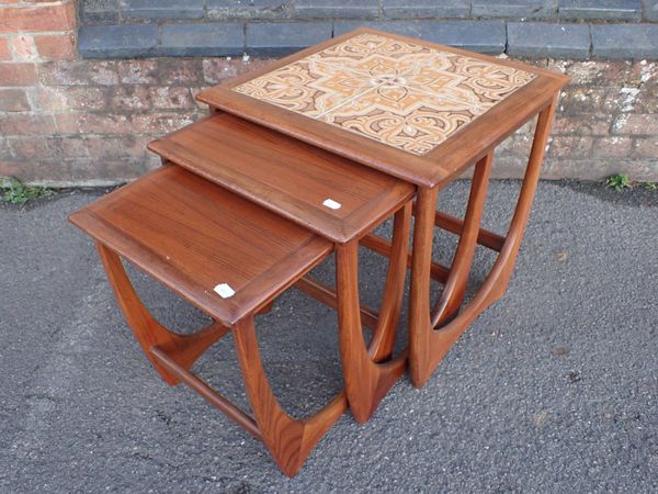 A G-PLAN NEST OF TEAKTABLES, WITH TILED TOP