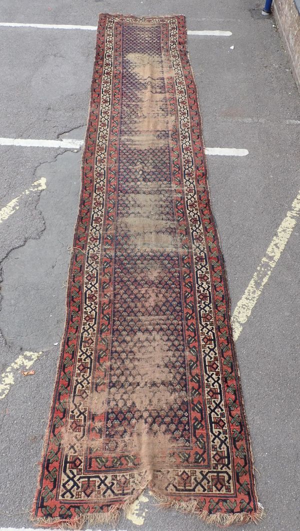 AN ANTIQUE NORTH-WEST PERSIAN RUNNER (EXAMINE)