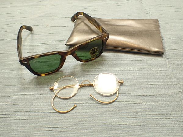 A PAIR OF YELLOW METAL FRAMED GLASSES