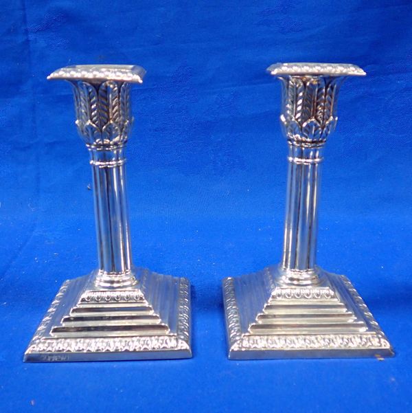 A PAIR OF SILVER CANDLESTICKS