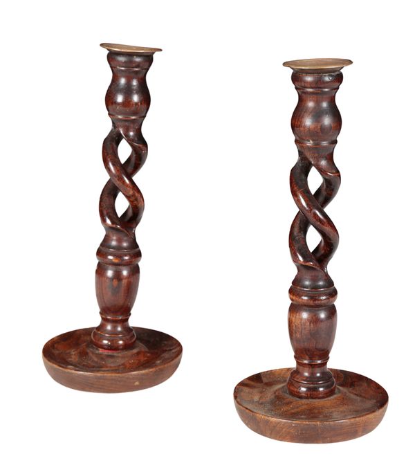 A PAIR OF OAK AND BRASS-MOUNTED CANDLESTICKS