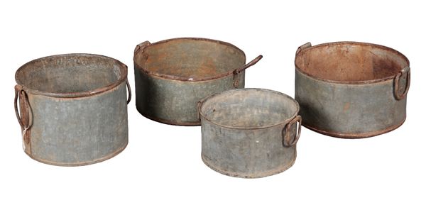 A GROUP OF FOUR GALVANISED JARDINIERES