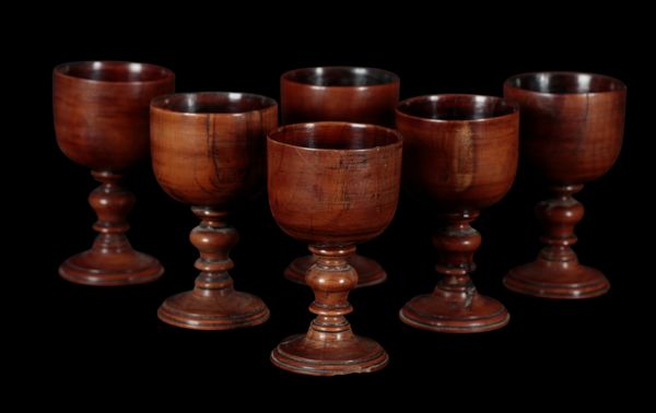 A SET OF SIX YEW WOOD WINE GOBLETS