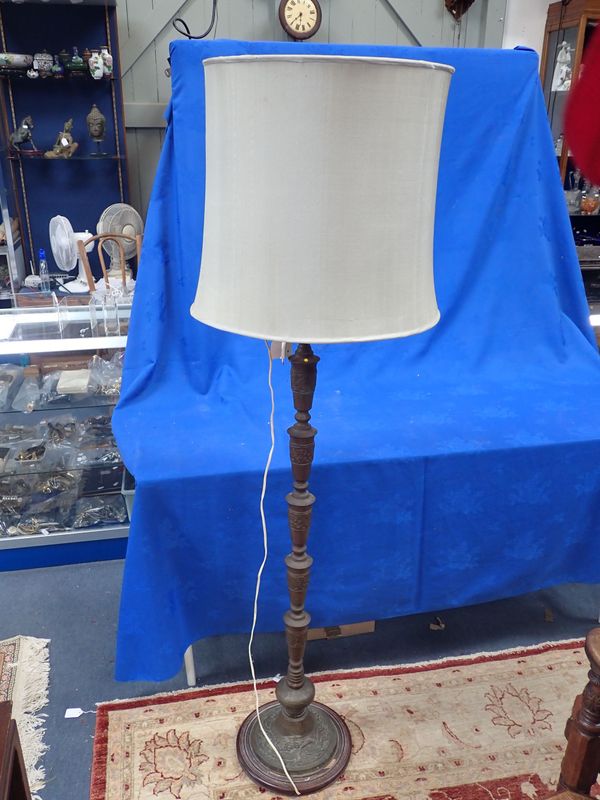 A CAST METAL STANDARD LAMP OF ASIAN DESIGN