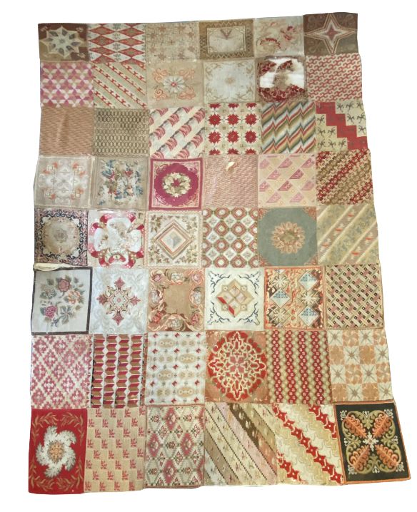 A WOOLLEN NEEDLEWORK PATCHWORK RUG OF VICTORIAN DESIGN