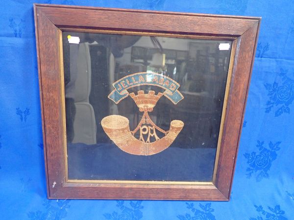 A FRAMED EMBROIDERY OF THE BADGE OF THE SOMERSET LIGHT INFANTRY