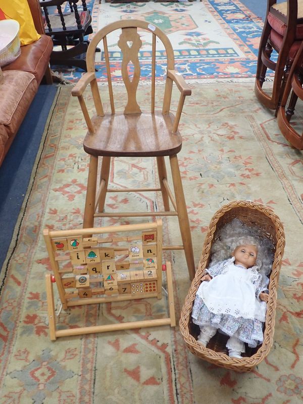 A WINDSOR STYLE CHILD'S HIGH CHAIR, A WICKER DOLL'S CRADLE