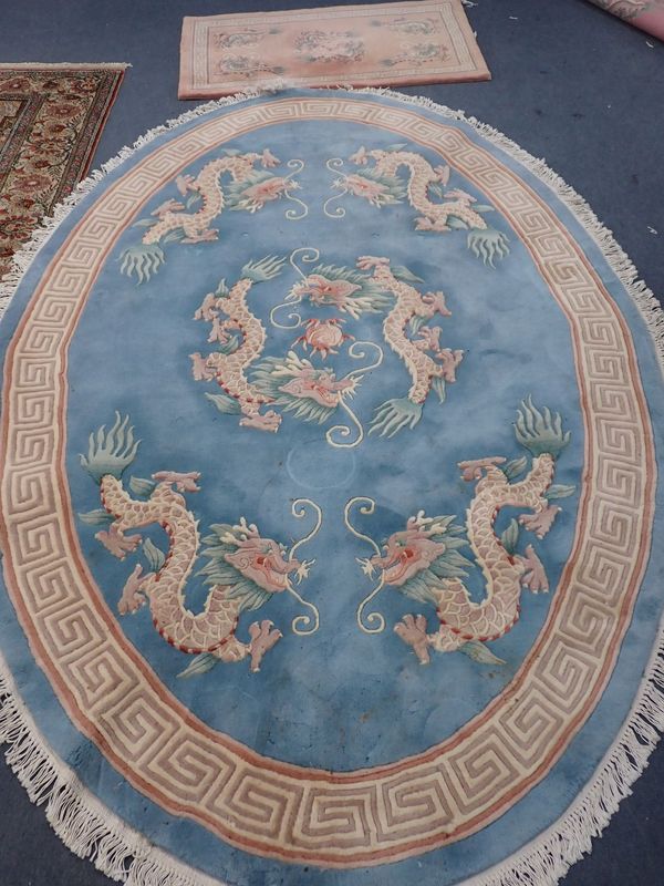 A CHINESE BLUE GROUND OVAL RUG