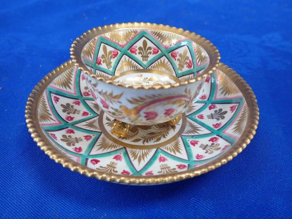 A  DERBY FOOTED CUP AND SAUCER