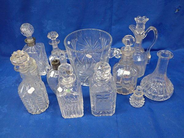 A LARGE CUT GLASS ICE BUCKET AND A COLLECTION OF DECANTERS