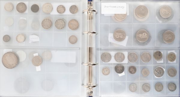 A COIN ALBUM CONTAINING MIXED WORLD COINS