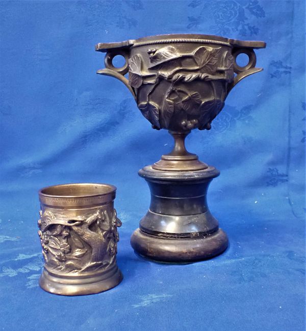 A BRONZE DECORATED URN ON STAND