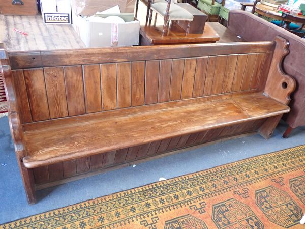 A VICTORIAN PINE CHURCH PEW, WITH SHAPED ENDS