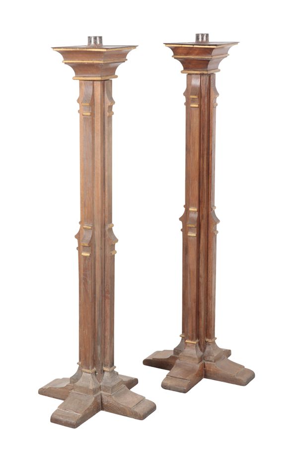 A PAIR OF VICTORIAN PARCEL GILT OAK TORCHERES OF ECCLESIASTICAL DESIGN