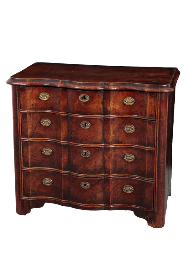 AN EARLY 18TH CENTURY CONTINENTAL WALNUT AND OAK SERPENTINE FRONTED COMMODE