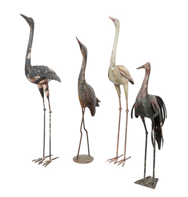 A GROUP OF FOUR PAINTED METAL STORKS