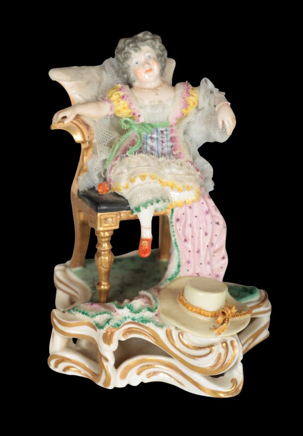 A 19TH CENTURY BLOOR DERBY PORCELAIN FIGURE OF A CHILD IN AN ARMCHAIR