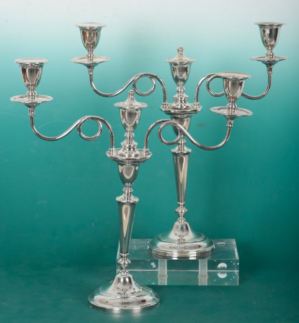 A PAIR OF ELIZABETH II SILVER THREE SCONCE CANDLEBRA OF NEO-CLASSICAL DESIGN