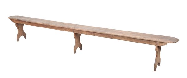 A STAINED PINE TRESTLE BENCH