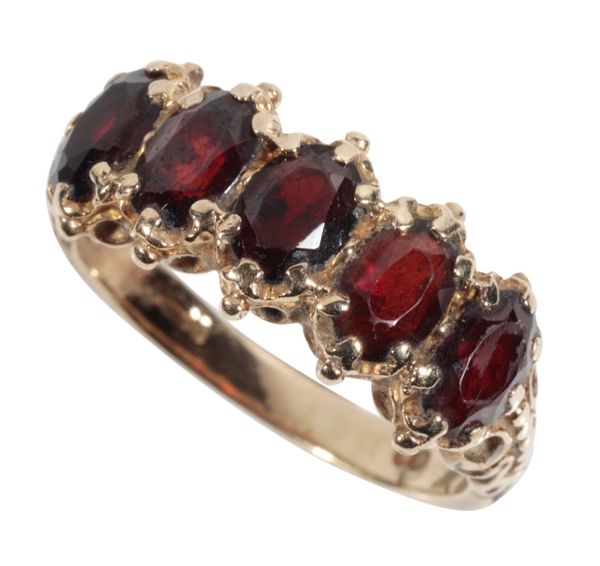 A FIVE STONE GARNET DRESS RING