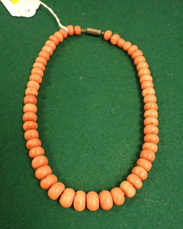 A ROW OF GRADUATED CORAL BEADS