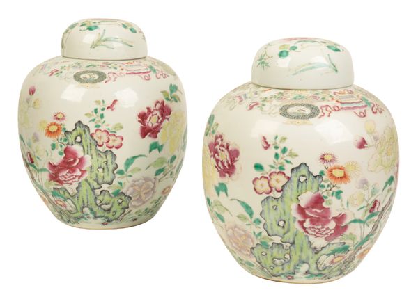A PAIR OF CHINESE FAMILLE ROSE JARS AND COVERS