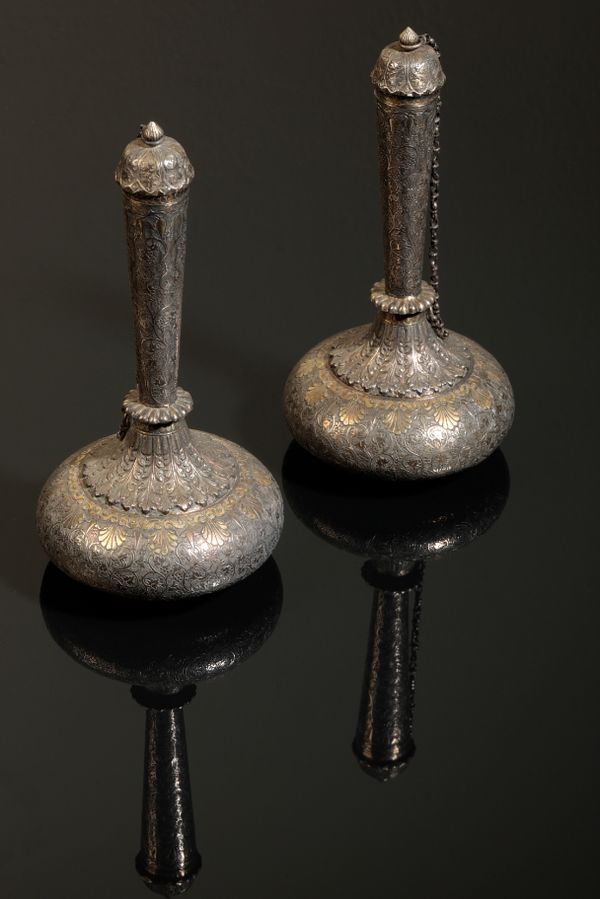 A PAIR OF INDIAN SILVER AND PARCEL-GILT 'SUHARE' (WINE FLASKS)