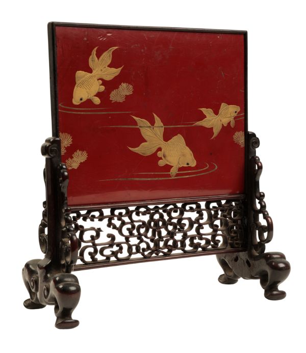 A JAPANESE RED AND BLACK LACQUER TABLE SCREEN