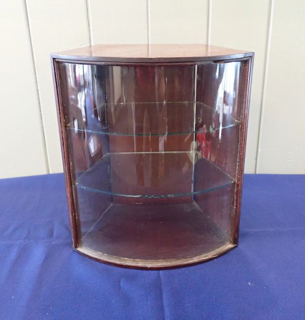 A SMALL BOW FRONTED DISPLAY CABINET