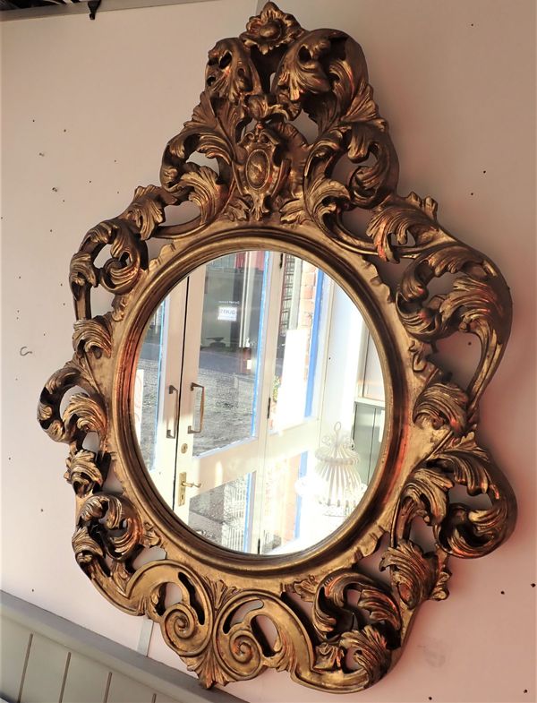 A ROCOCO GILTWOOD OVAL MIRROR