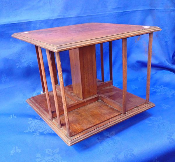 AN EDWARDIAN WALNUT REVOLVING TABLE TOP BOOKCASE