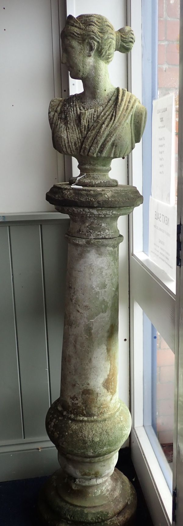 A RECONSTITUTED STONE GARDEN COLUMN AND BUST