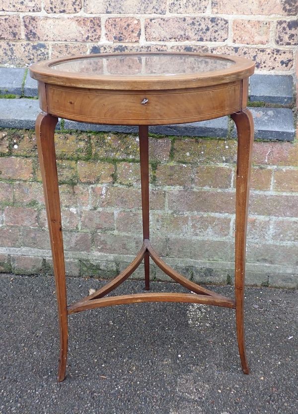 AN EDWARDIAN MAHOGANY CIRCULAR BIJOUTERIE CABINET