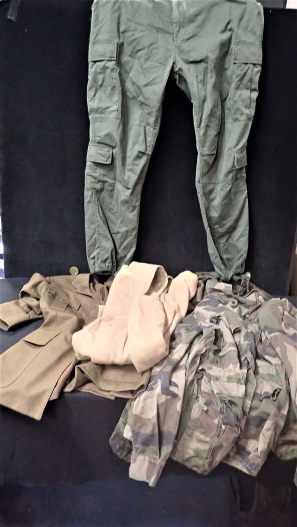 A BOX OF MILITARY UNIFORMS